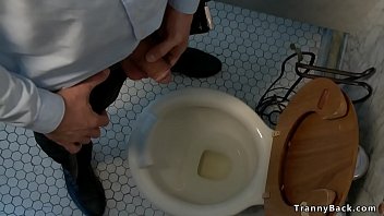 Shemale wanks dudes cock while pissing